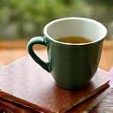 Warm cup of tea and a notebook in morning light